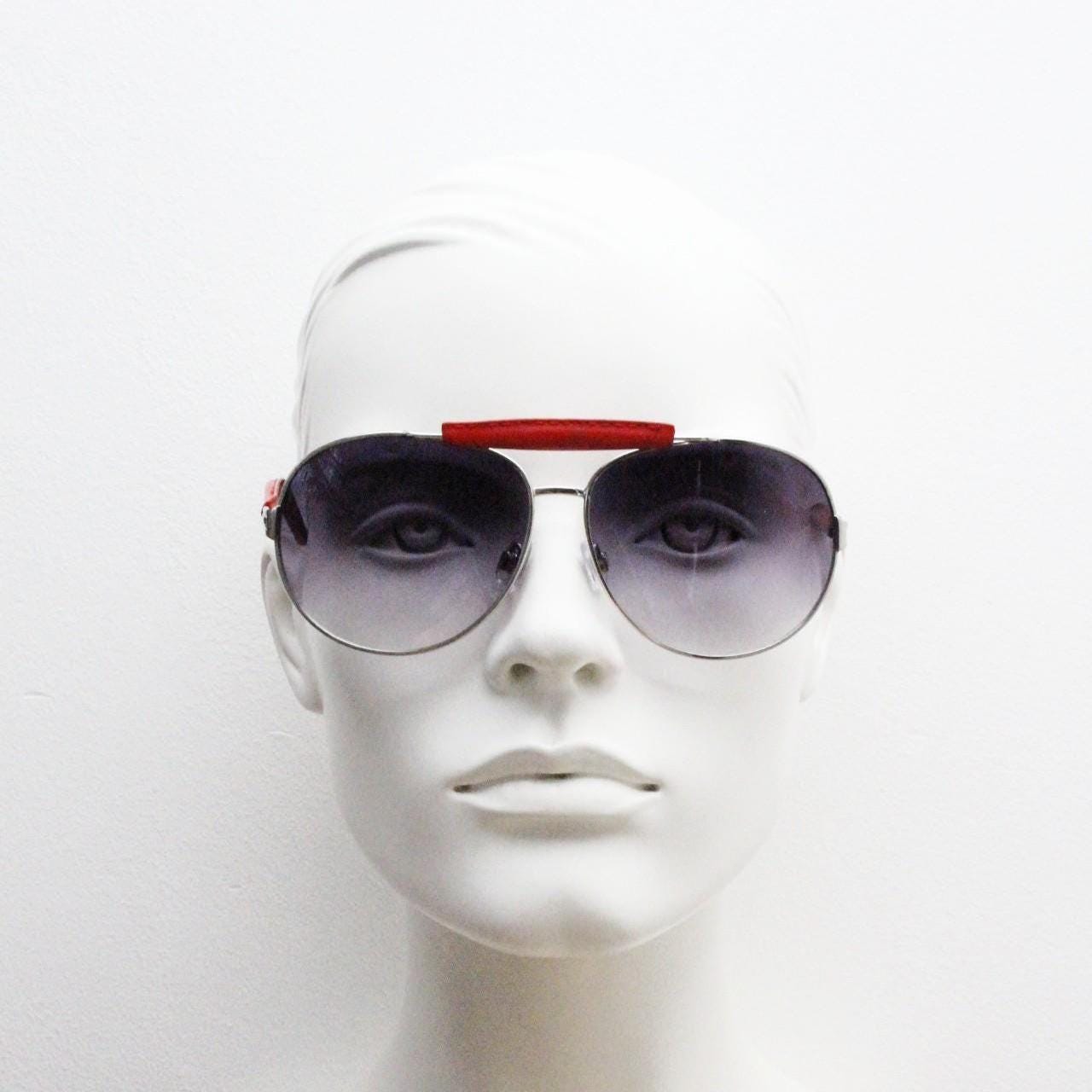Y2K vintage aviator sunglasses. 2000's silver metal frame with exaggerated bridge in red trim. 70s racing design. 00's NOS aviators