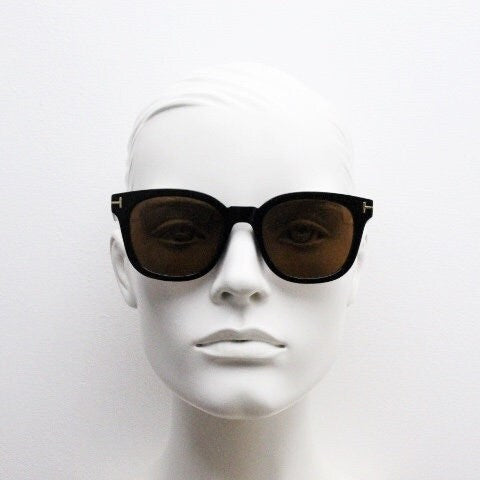 Tom Ford vintage wayfarer design sunglasses made in Italy. Slightly cat eye form in plain black gloss acetate with gold arms