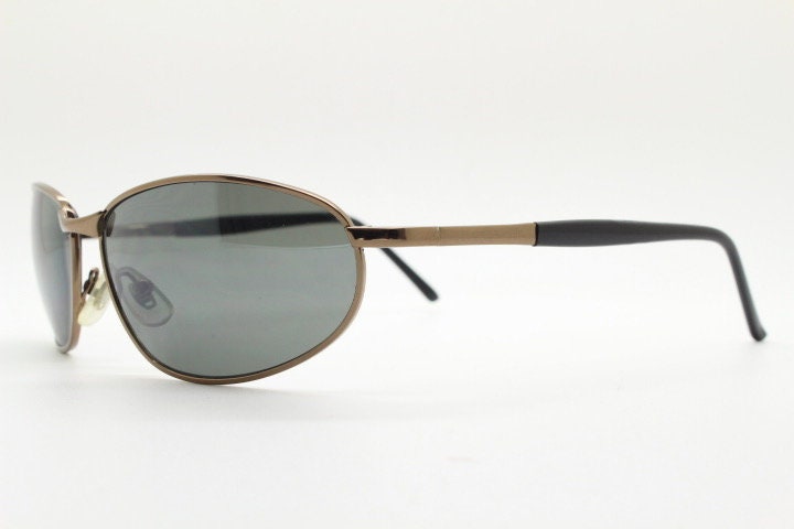 Y2K vintage small bug eye sunglasses. Curved brown chrome metal frame with black arms. Unused 2000s NOS