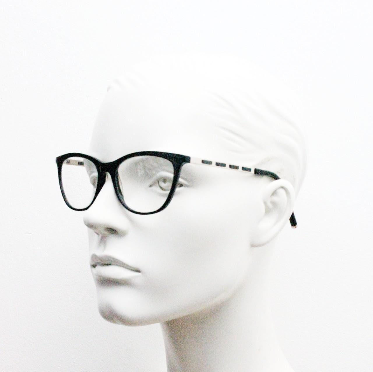 Vintage elegant cat eye glasses by Heritage. Black gloss acetate optical frames with leather lattice arms. Prescription RX cateye spectacles
