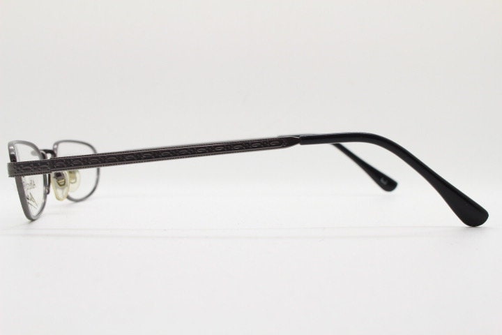 Alberta Ferretti 90s vintage oval eye glasses made in Italy. Small grey metal optical frame with ornate arm pattern. Prescription RX. NOS