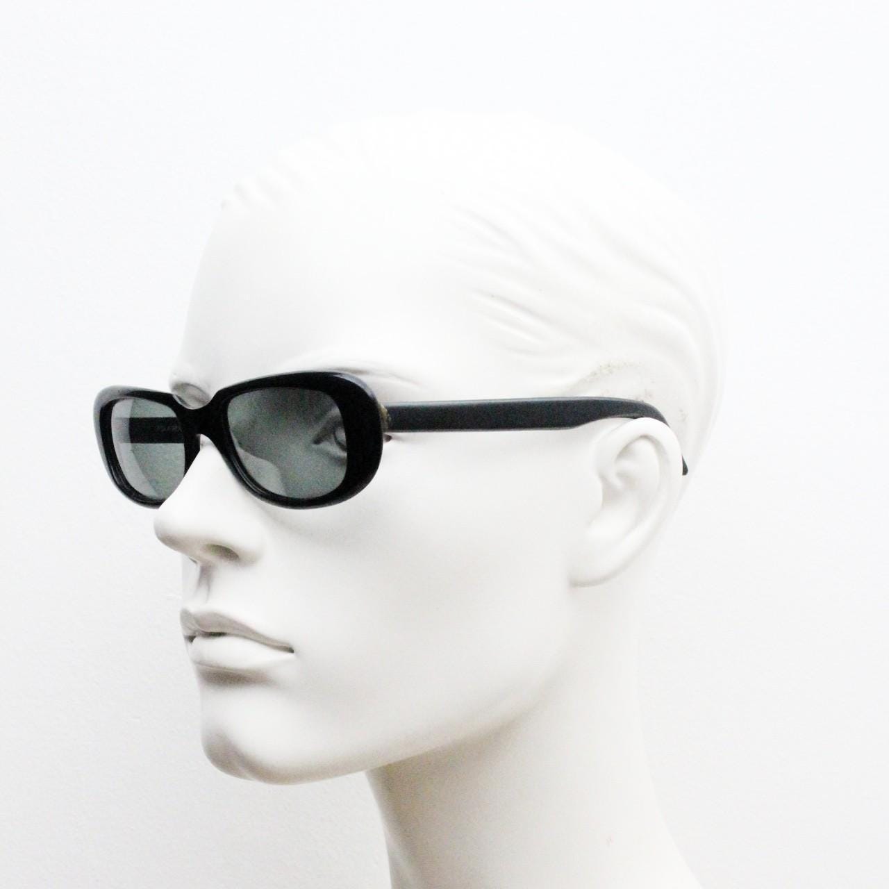 Polaroid 60s vintage rectangular sunglasses made in England. Authentic plain black frame with atmospheric curved lenses. Mens mod