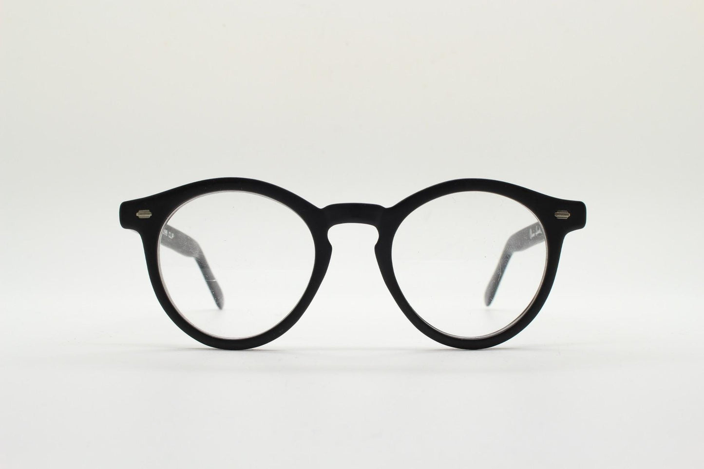 Oliver Smith round eye glasses. Black matt finish optical frames with protruding corners and keyhole bridge. Prescription RX eyeglasses