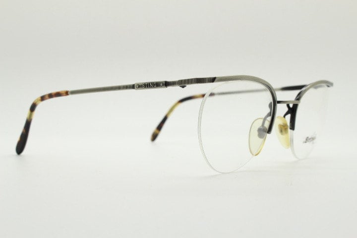 Sting 90s vintage round eye glasses. Minimal pewter finish metal half frame brow line optical frames. Prescription eyeglasses. RX. NOS