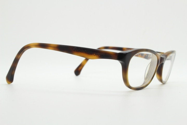Calvin Klein Jeans modified cat eye glasses model CKJ918. Tortoise gloss low profile acetate optical frames. Prescription eyeglasses. RX