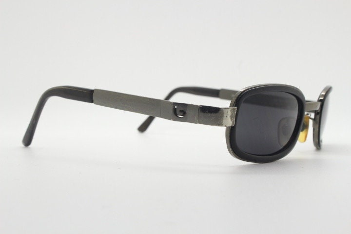 Byblos 90s vintage low profile rectangular sunglasses made in Italy. Gunmetal grey chrome frame with black insets and cut out arm logo's