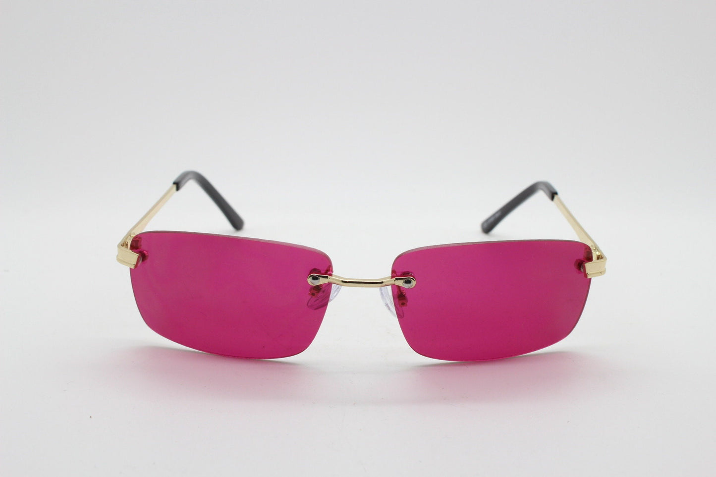 Y2K vintage frameless pink sunglasses. Rectangular lenses with gold bridge and arms. 2000s club kids. 00's. 90s Rave