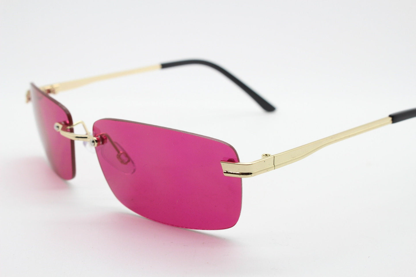 Y2K vintage frameless pink sunglasses. Rectangular lenses with gold bridge and arms. 2000s club kids. 00's. 90s Rave