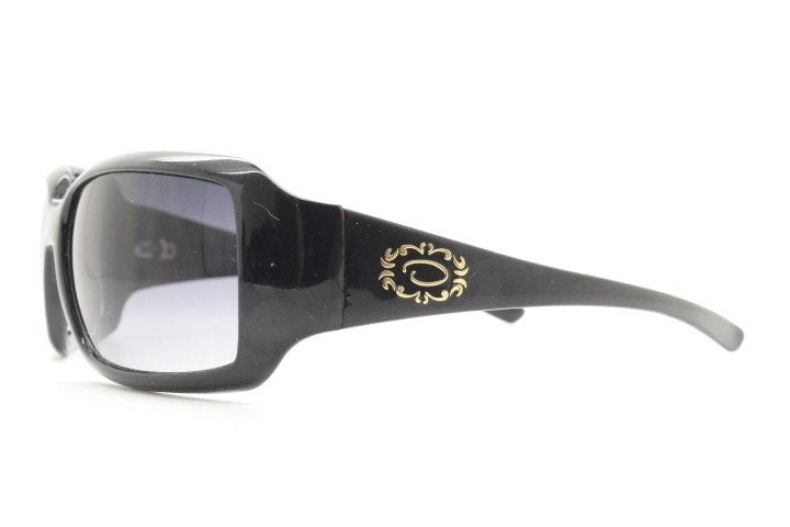 Oscar De La Renta Y2K vintage shield sunglasses. All black gloss wrap around visor with graduating lenses. 2000's bug eye mini mask
