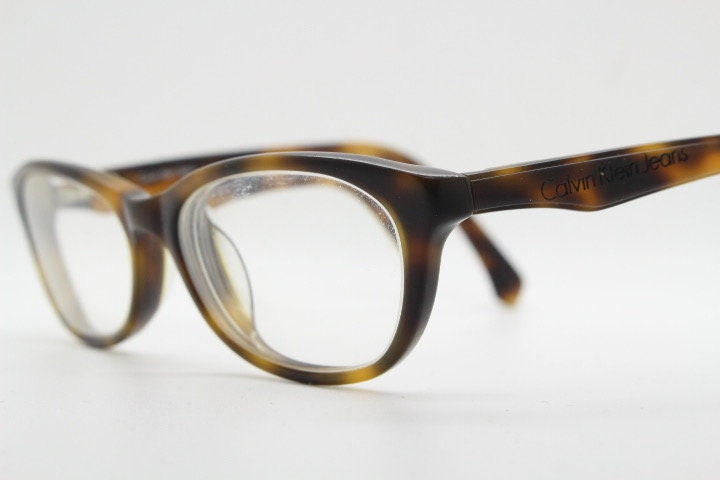 Calvin Klein Jeans modified cat eye glasses model CKJ918. Tortoise gloss low profile acetate optical frames. Prescription eyeglasses. RX