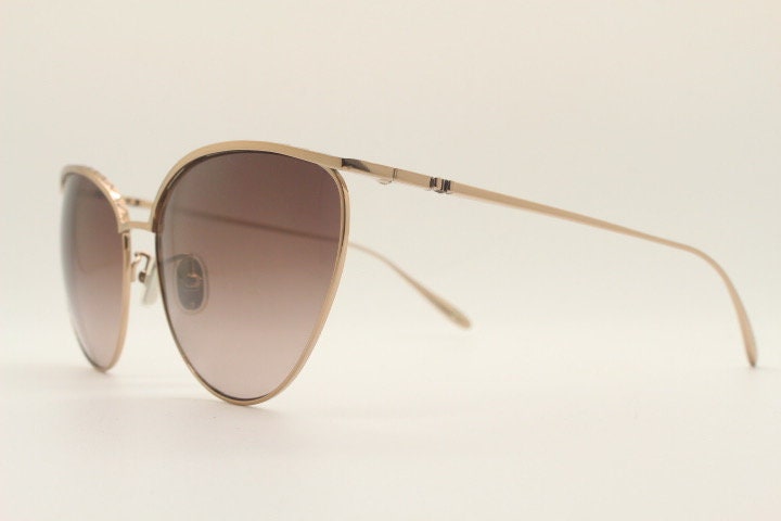 Carolina Herrera minimal cat eye sunglasses model SHN069 made in Italy. Women's  gold titanium cateye frame with brown lenses. Vintage NOS