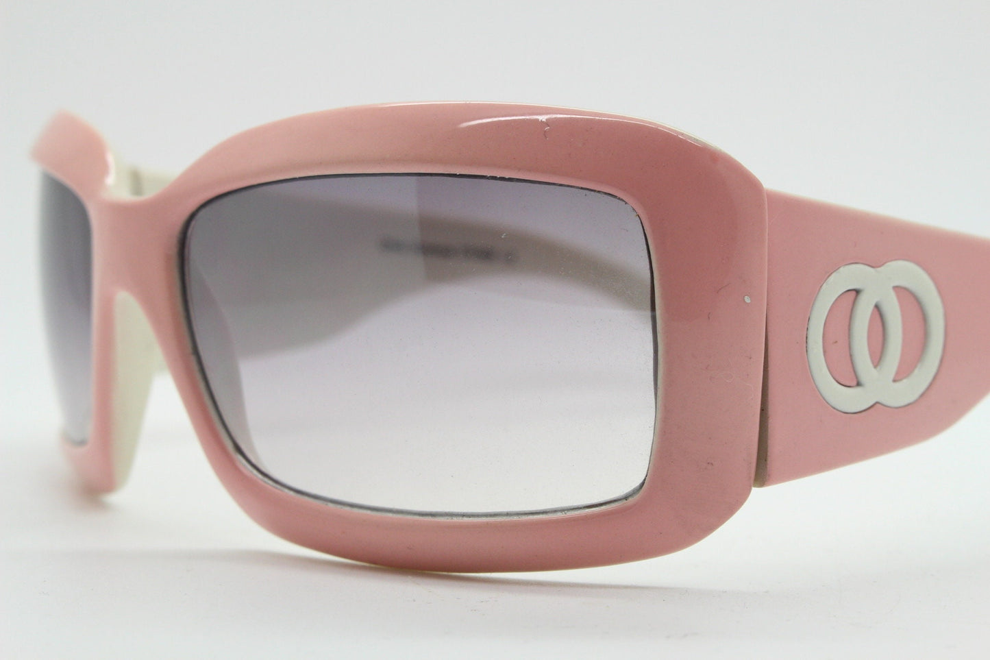 Y2k vintage rectangular wrap around bug eye sunglasses. Curving pink frame with big chain link logo. Rave shield fashion grail. 2000s NOS