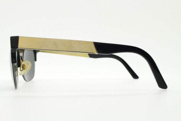Retrosuperfuture vintage flat top half frame sunglasses hand made in Italy. Black gloss acetate front with tall golden arms