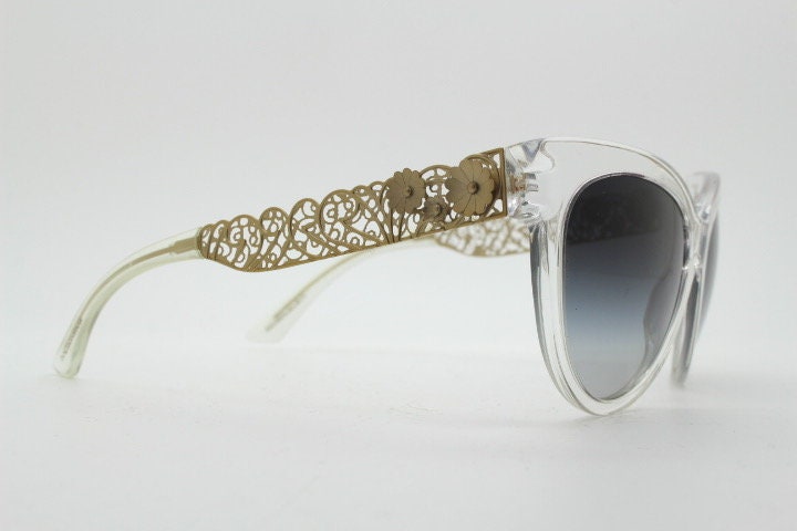 Dolce and Gabbana oversized cateye sunglasses model 4211. Womens transparent cat eye with cut-out florid metal arms and smoky lenses. NOS