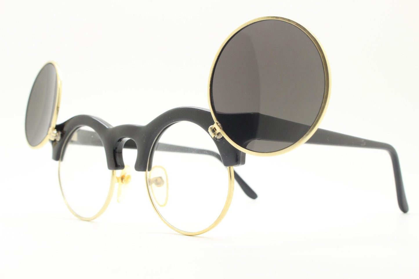Vintage 80s round flipper sunglasses. Black gloss frame with clear lenses and incredible side flip up shades . BNWT unused NOS