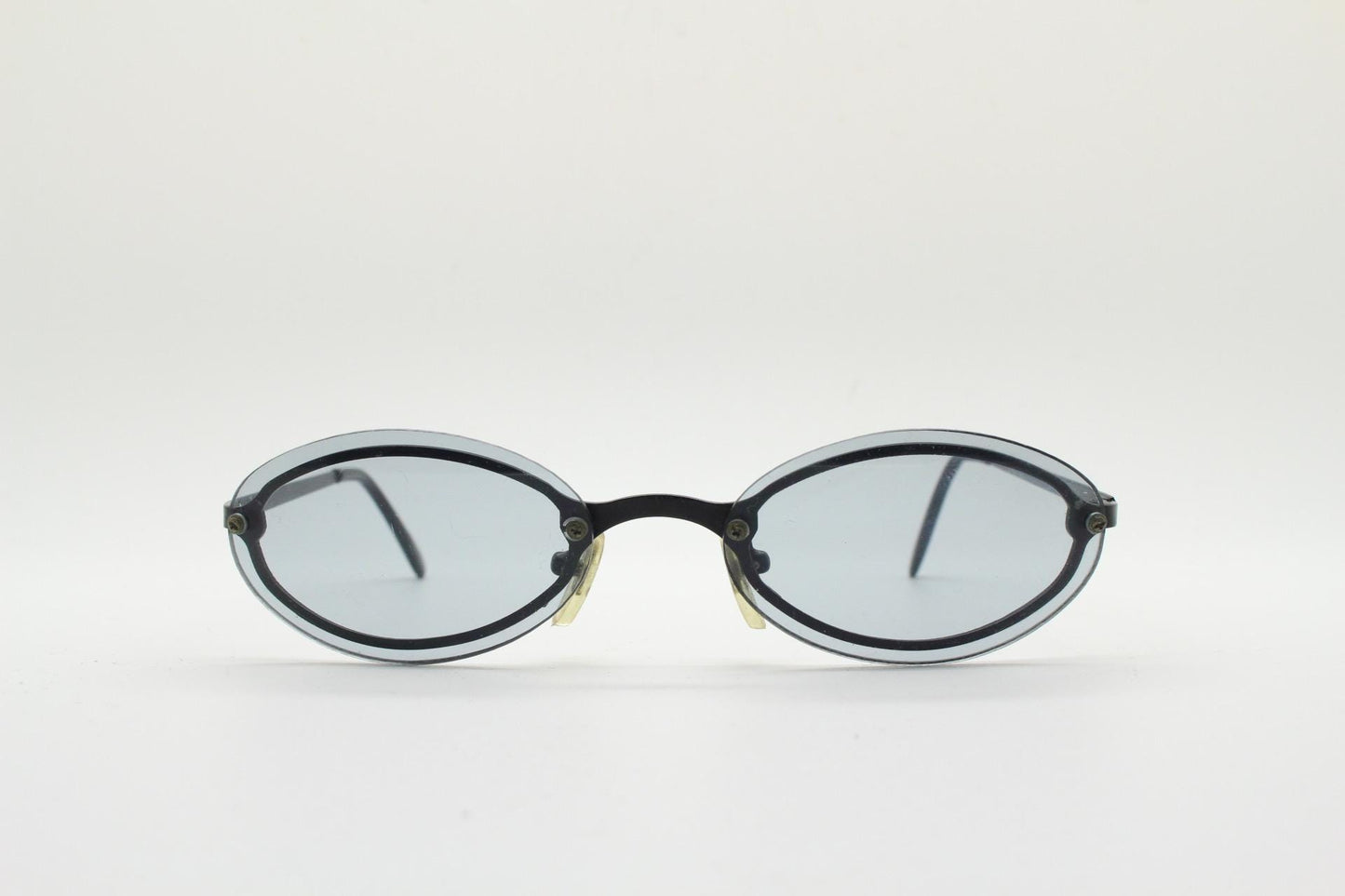 90s vintage small oval sunglasses. Minimal black metal frame with clever overlapping lens design in light tone grey. Micro. Steampunk. NOS