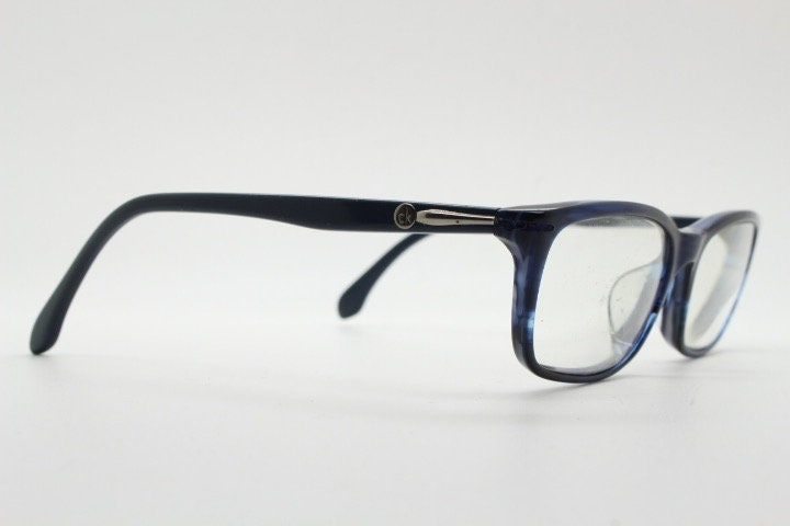 Calvin Klein rectangular low profile eye glasses. Dark navy blue gloss acetate optical frames. Prescription eyeglasses. RX