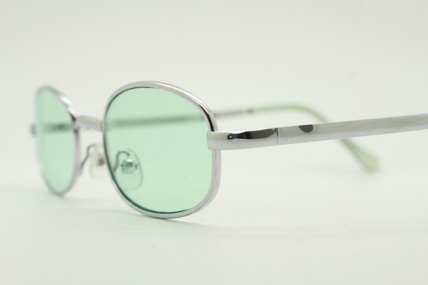 90s micro foldable oval sunglasses. Light green lenses in a small silver folding compact frame. Folder. Rave 2000s. Y2K. NOS