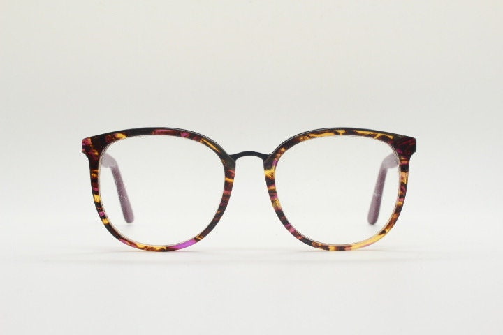 Kenzo vintage round eye glasses made in France. Tortoise with purple tones and matching arm sections. Womens Prescription Optical frames. RX