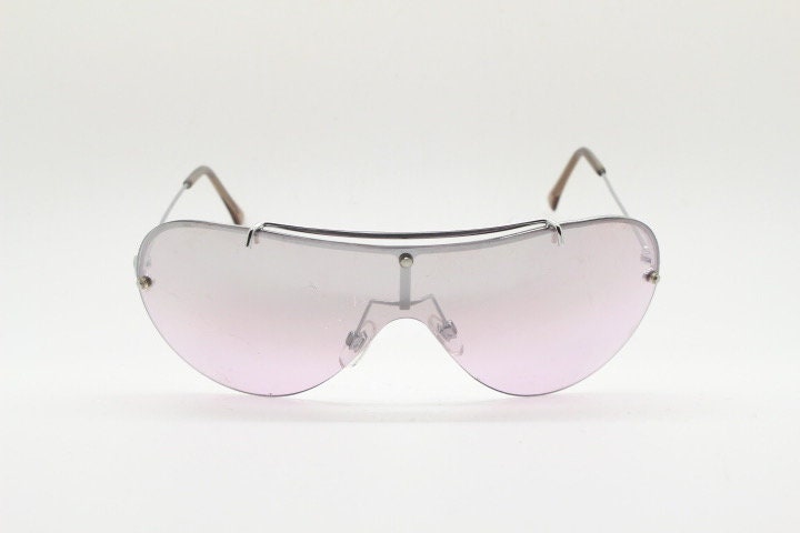 Y2K vintage visor shield sunglasses. Silver chrome half frame with pink wraparound mono lens and mirror glaze. Mini mask. 00's. 2000's NOS