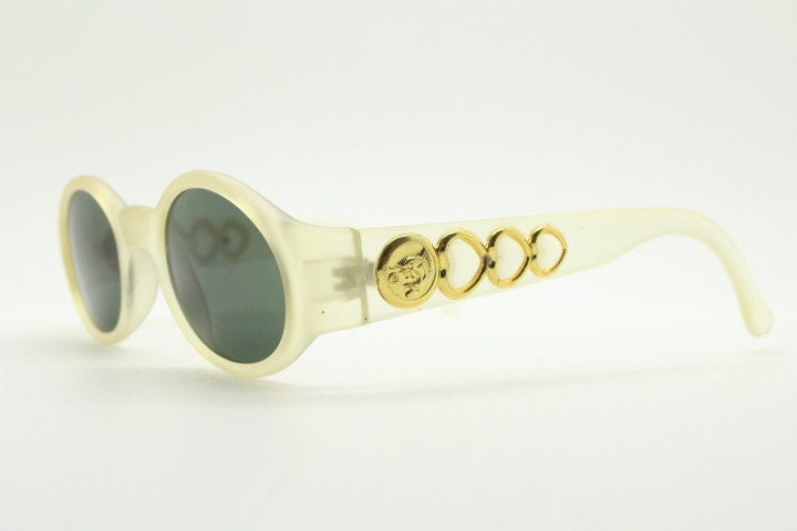 Vintage 90s oval transparent sunglasses. Frosted frame with dark green lenses and heart shaped chain link arms. Unworn NOS