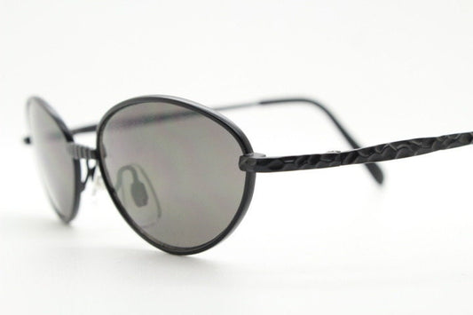 90s vintage oval sunglasses. Minimal plain matt black metal frame with unusual indented arm patterns. Unused NOS