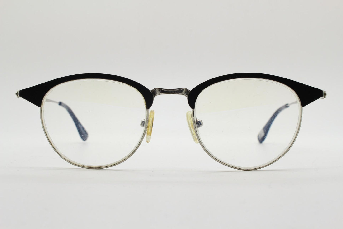Lupo and Co round eye glasses with pointed corners. Flat metal silver optical frames with black browline. Prescription eyeglasses. RX