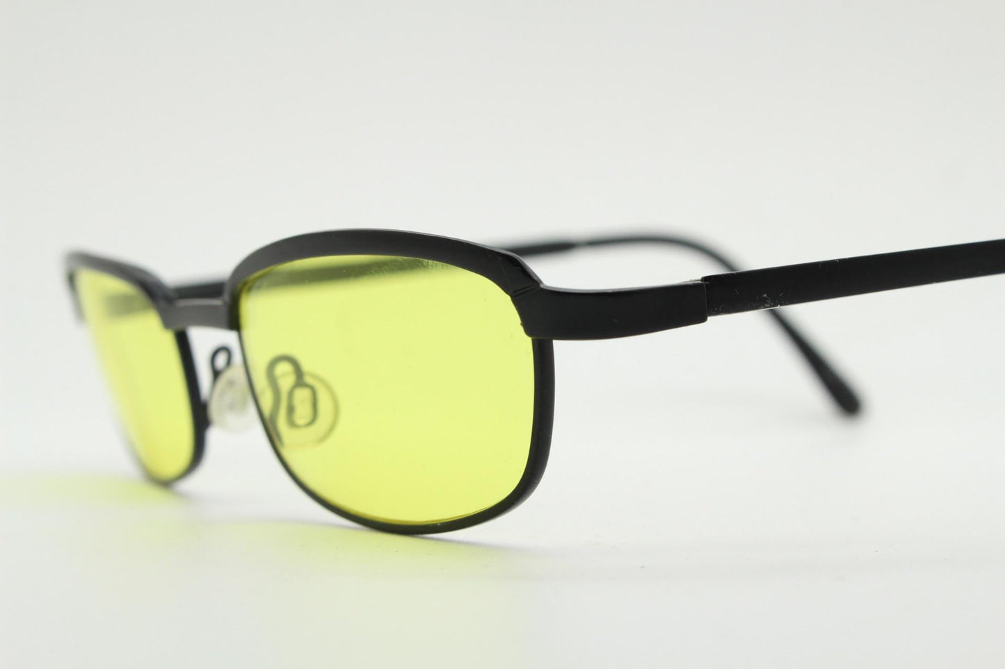 Vintage small rectangular sunglasses. Authentic quirky 90s design in a matt black solid metal frame with bright yellow lenses. 2000s. NOS