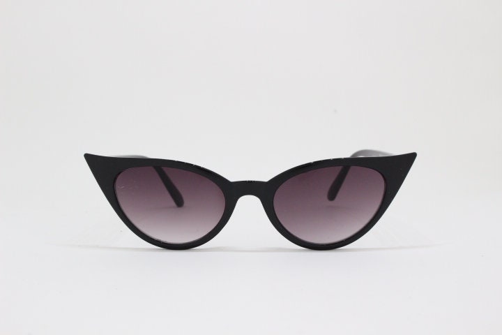 Y2K vintage pointed cat eye sunglasses. Black slender frame with graduated lenses. Womens 50s style rockabilly, pin up shades