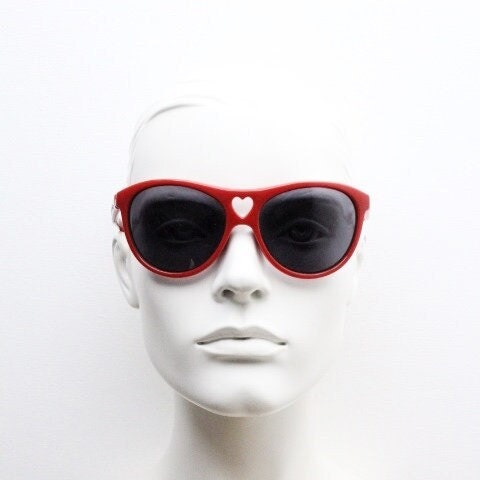 Moschino oversized Y2K vintage sunglasses. Characteristic crimson red acetate frame with cut out heart bridge. 2000s