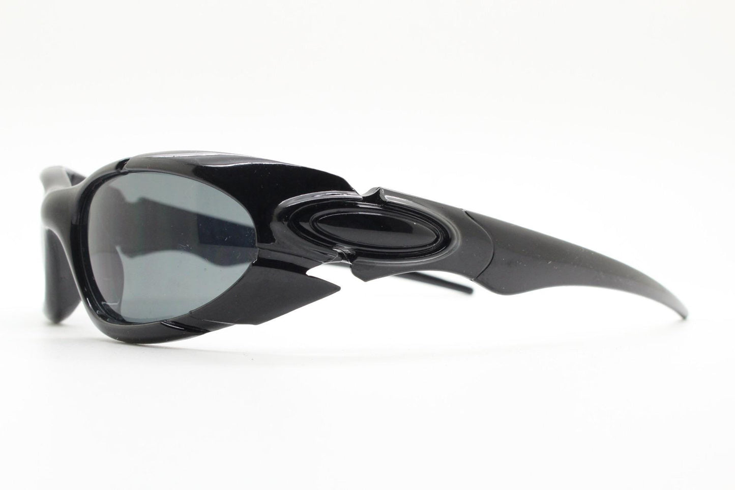 90s vintage sports shield sunglasses. All black gloss aerodynamic wraparound with many stylised features. 2000's. Hells angel uber fashion