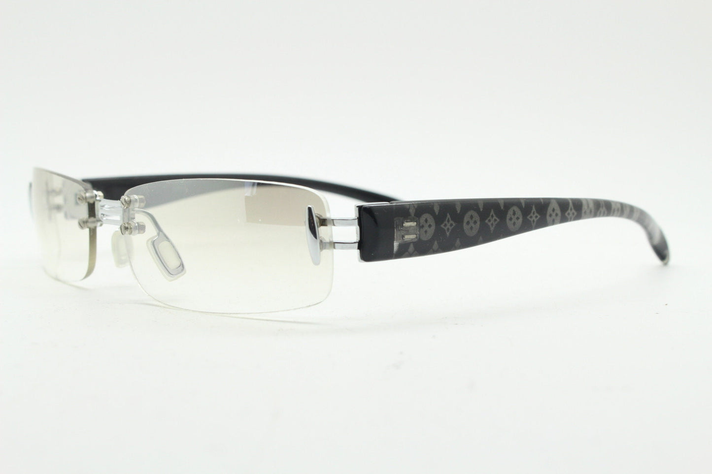 Y2K vintage frameless sunglasses. Silver chrome trim with patterned arms and extra light tone graduated curved mirror lenses. 2000's. 90s
