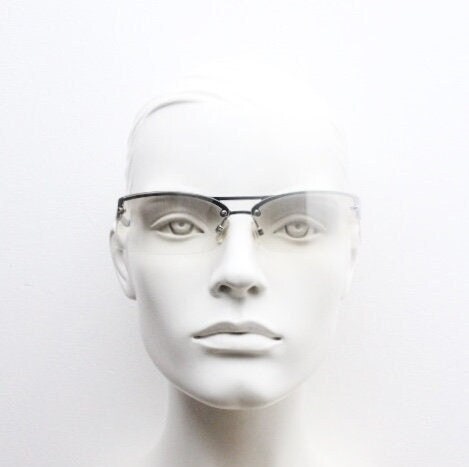 Y2K vintage wraparound sunglasses. Sick fashion grail half frame in silver chrome with extra light tone curving mirrored lenses. 2000's NOS