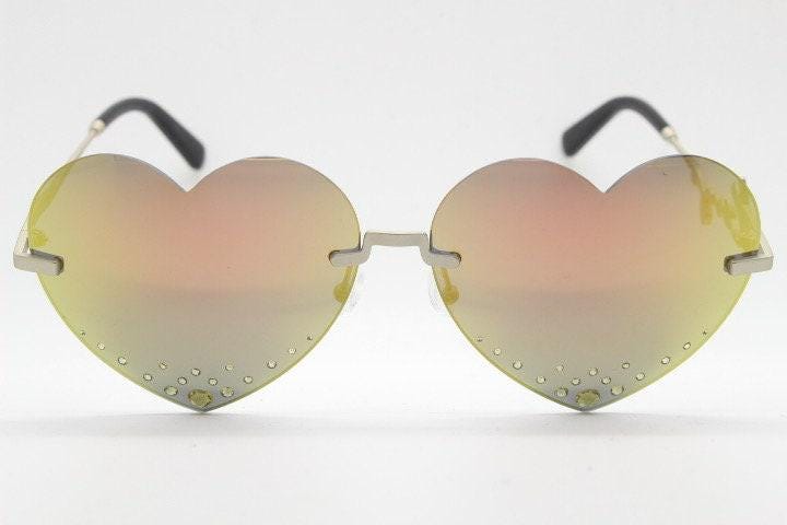 Kenzo mirror heart shaped frameless sunglasses model KZ40005U. Instant classic design with diamantes and big spell out arm logo. NOS