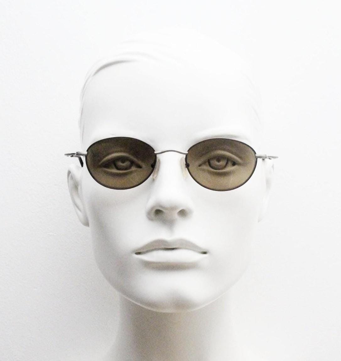 90s oval vintage metal sunglasses. Minimal satin finish bronze and brown metal frame with kinked curving arms. Steampunk. Unused NOS