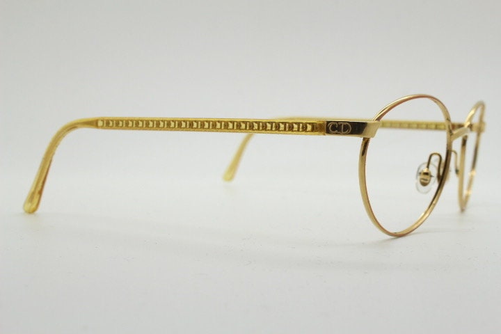 Christian Dior 90s vintage oval eye glasses made in Austria. Lustrous gold finish optical frame with CD chain link arms. Prescription RX NOS