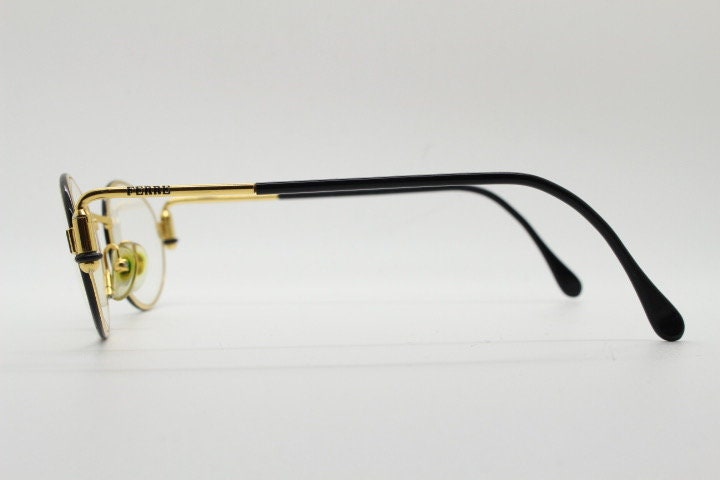 Gianfranco Ferre 90s vintage oval eye glasses made in Italy. Black and gold metal tech design optical frame. Prescription RX. NOS