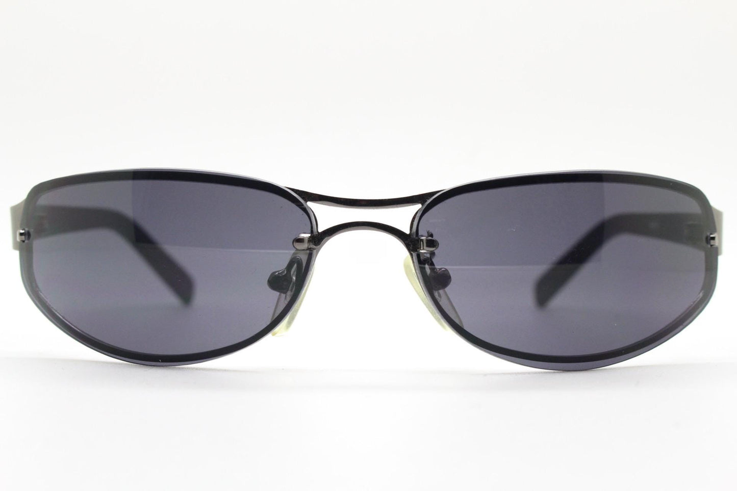Y2K vintage small bug eye oval sunglasses. Gunmetal grey chrome metal frame with curved bug eye lenses and matt black arms. 2000's NOS
