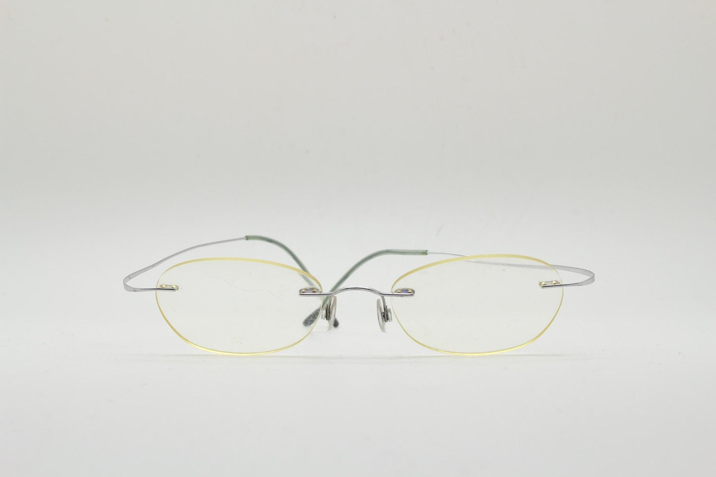 Silhouette frameless oval eye glasses. Extremely minimal lightweight titanium optical frame with springy hingeless arms. 2000s Vintage