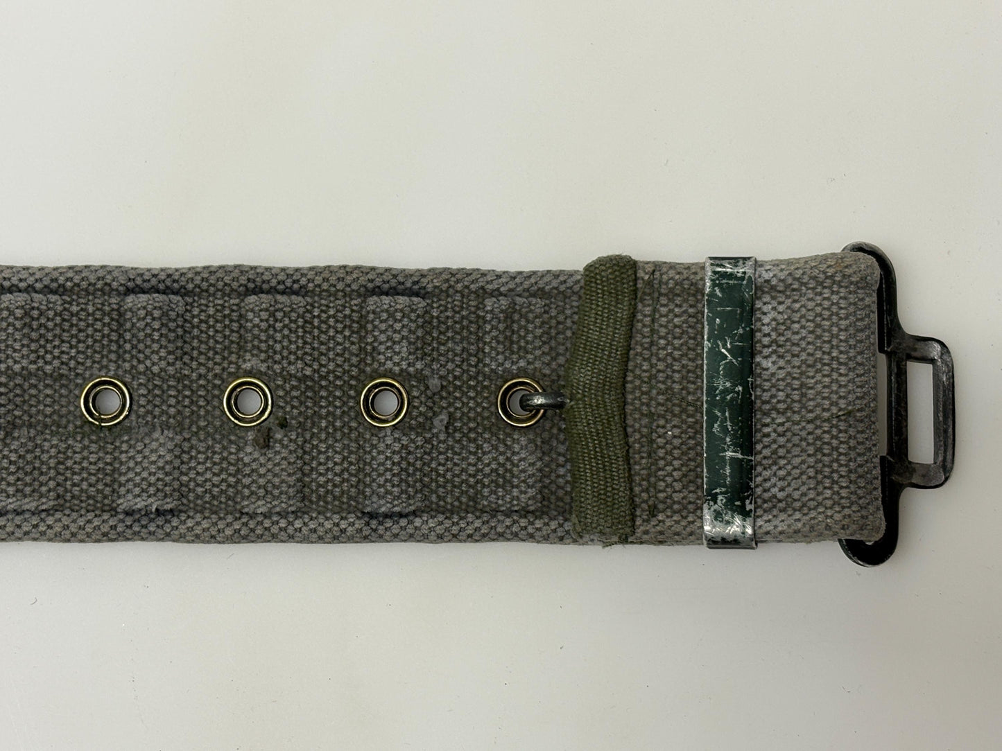 80s vintage real army webbing belt. Thick woven canvas in khaki green. Distressed look. Metal hardware. Fully adjustable. Tactical webbing