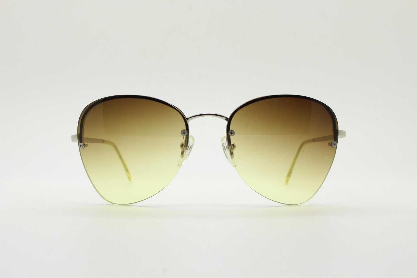 90s vintage modified teardrop aviator sunglasses. Minimal metal silver chrome half frame with compelling lenses. Teardrop aviators. NOS