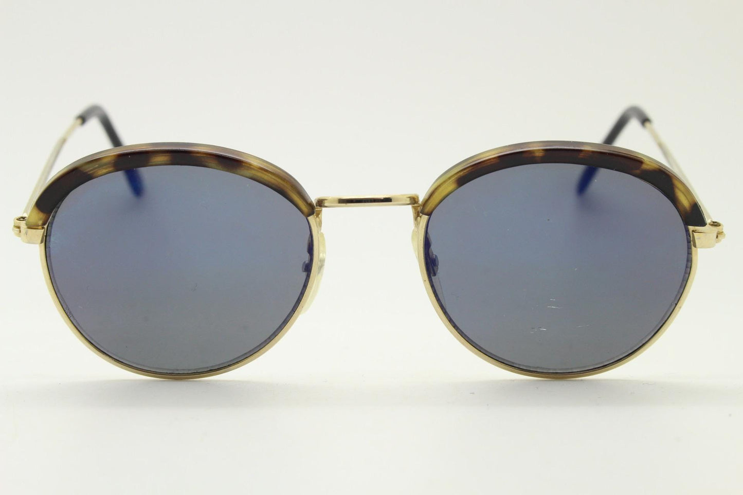 90s round vintage sunglasses. Gold frame with tortoise brows, blue mirror lenses and intricate embossed arm patterns. 1930's style