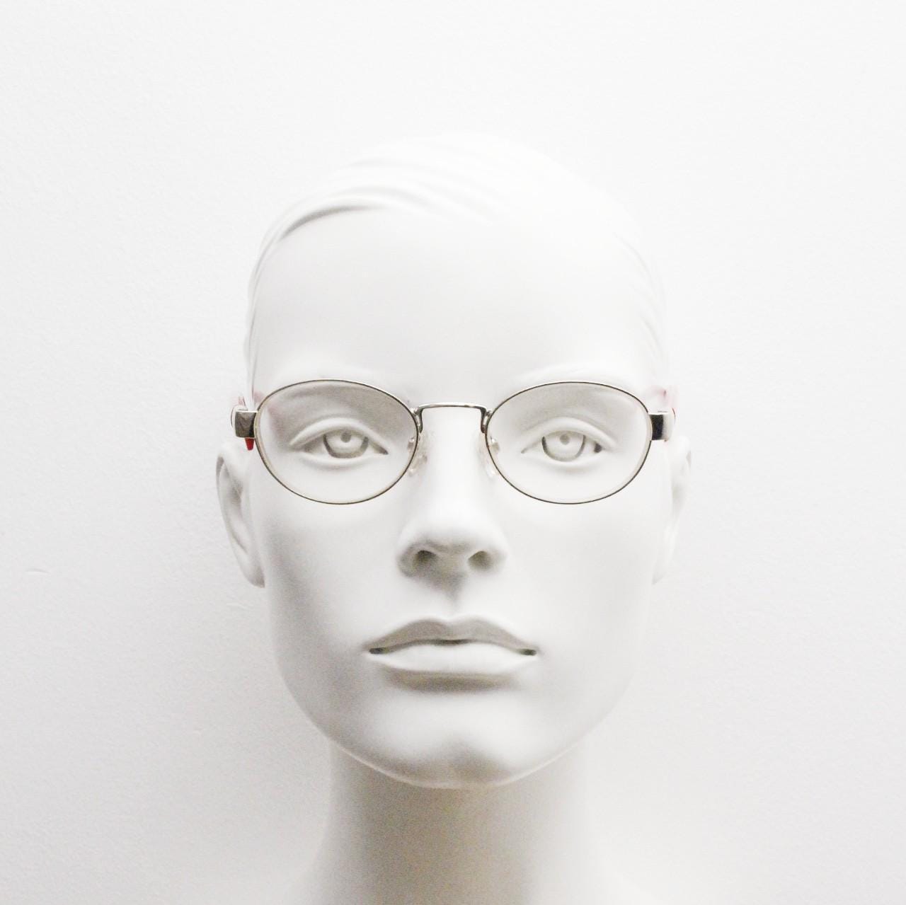 Red or Dead Y2K vintage oval eye glasses. Green or red interchangeable arms on a chrome metal frame. Optical prescription eyeglasses. RX