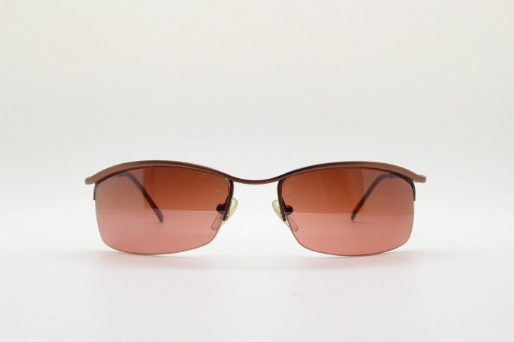 Y2K vintage curved rectangular sunglasses. Minimal half frame brow line design in brown satin finish with mid tone lenses. 2000's. 00's NOS