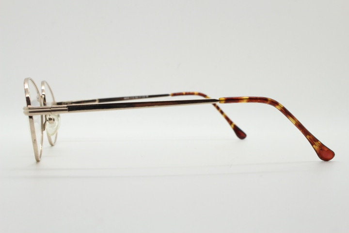 90s vintage oval eye glasses. Bright golden optical frames with coloured enamel brows. Prescription RX spectacles. Clear lens NOS