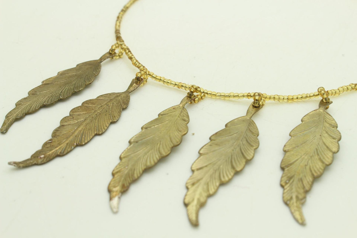 80s vintage gold beaded necklace with large dangling leaves . Charming statement piece. Country and western. Native american