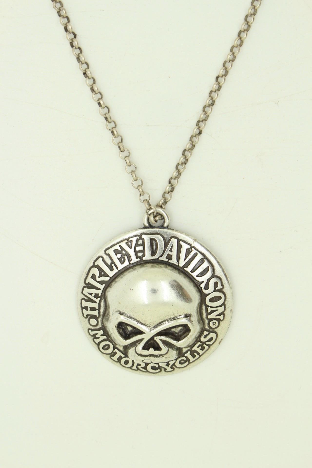 90s vintage Harley Davidson Motorcycles disc pendant necklace. Solid metal silver curved shield with standout skull on adjustable chain