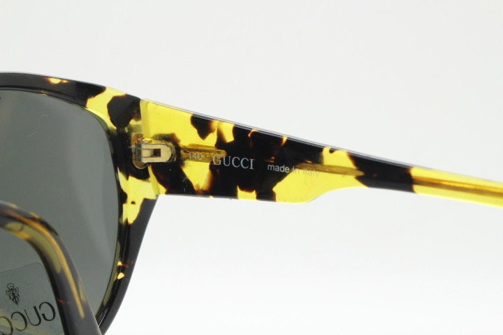 Gucci 90s vintage large oval sunglasses model 2135 made in Italy. Vibrant amber and mottled brown bug eye. NOS