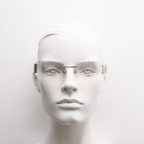 Y2K vintage wraparound sunglasses. Minimal frameless light tone curved mirrored lenses with silver chrome trim. 2000's. 90s. 00s. NOS