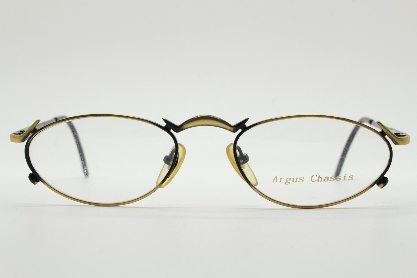 90s vintage oval eye glasses by Argus Chassis. Brushed bronze optical frames with dynamic spikes. Prescription cosplay fetish spectacles NOS